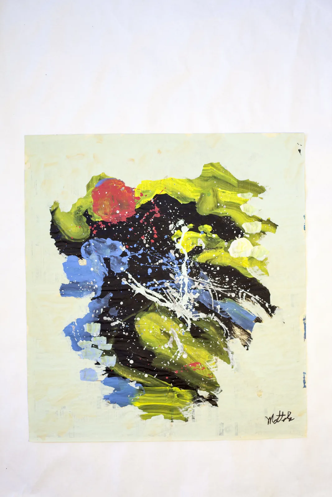 Abstract work by Fil Mottola with black, green, blue, and splattered white paint